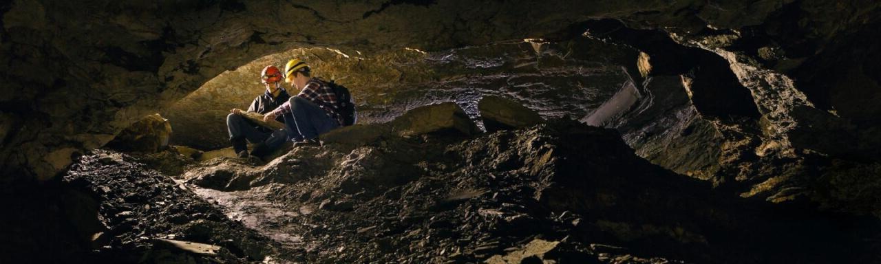 Two RCI student studying in a cave